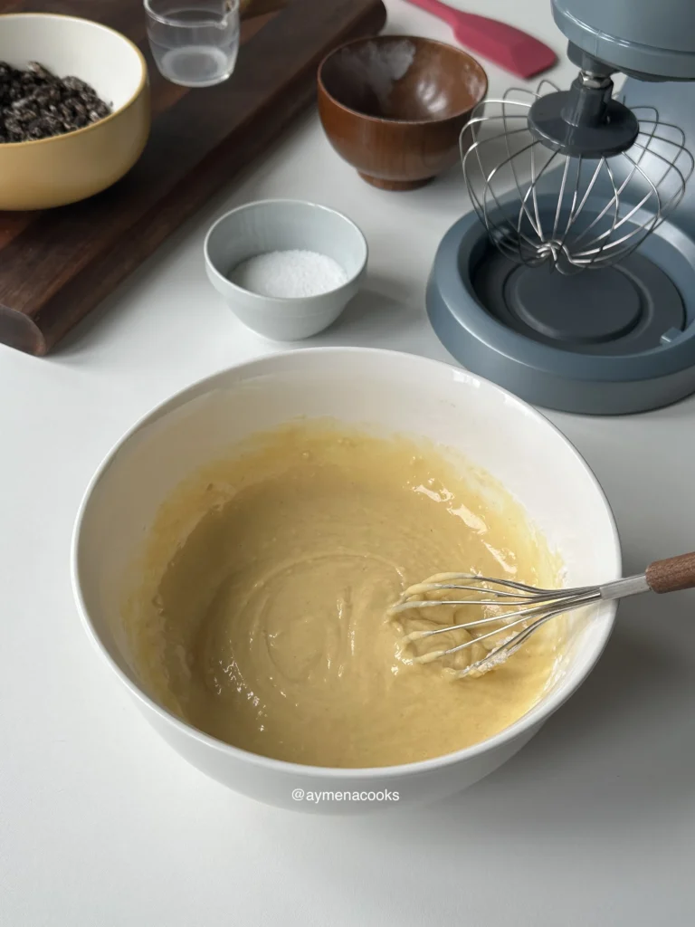 The flour mixture whisked into the egg yolks to make a smooth, pale yellow batter.