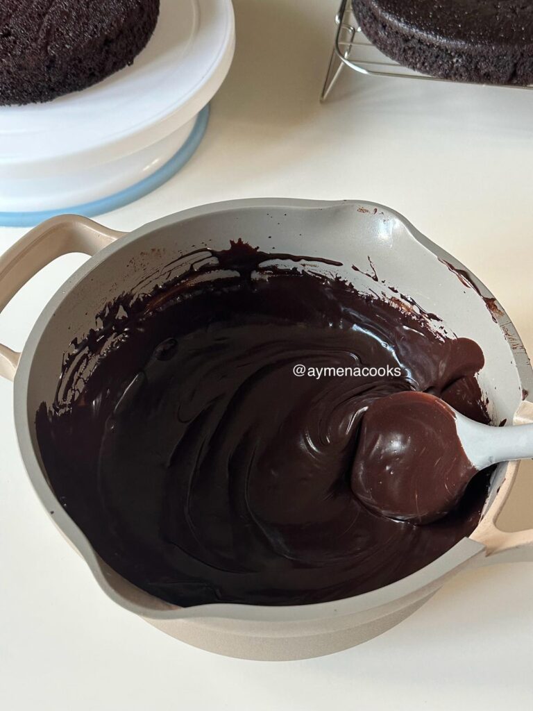 Smooth glossy chocolate fudge frosting ready to spread.