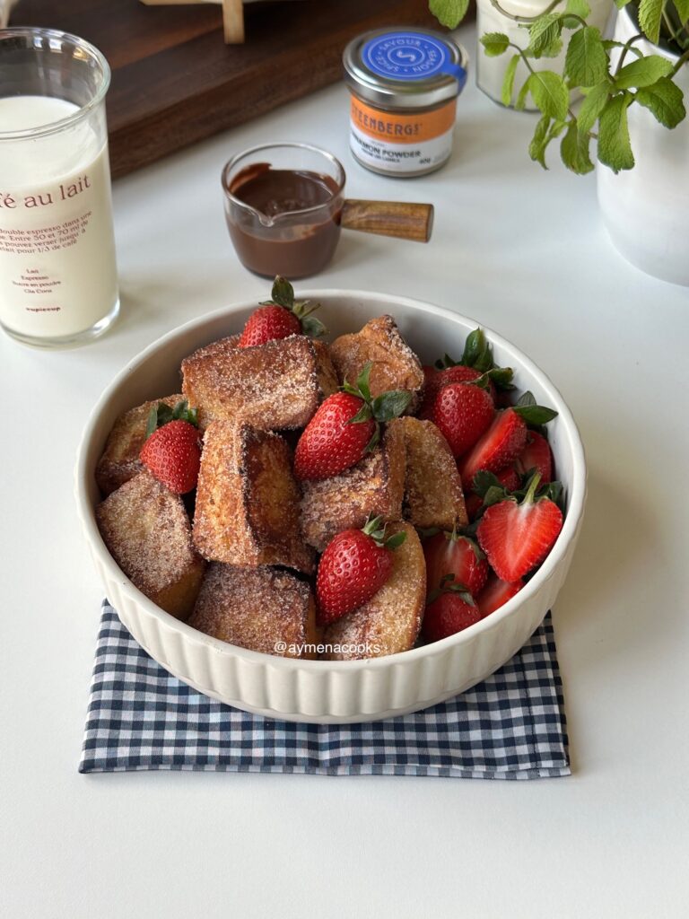 Cinnamon French toast bites served with fresh strawberries, whipped cream and powdered sugar.