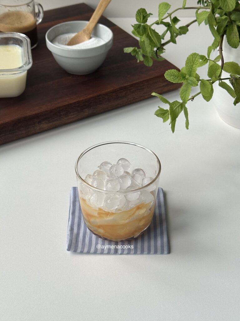 ice added to a caramel-lined glass