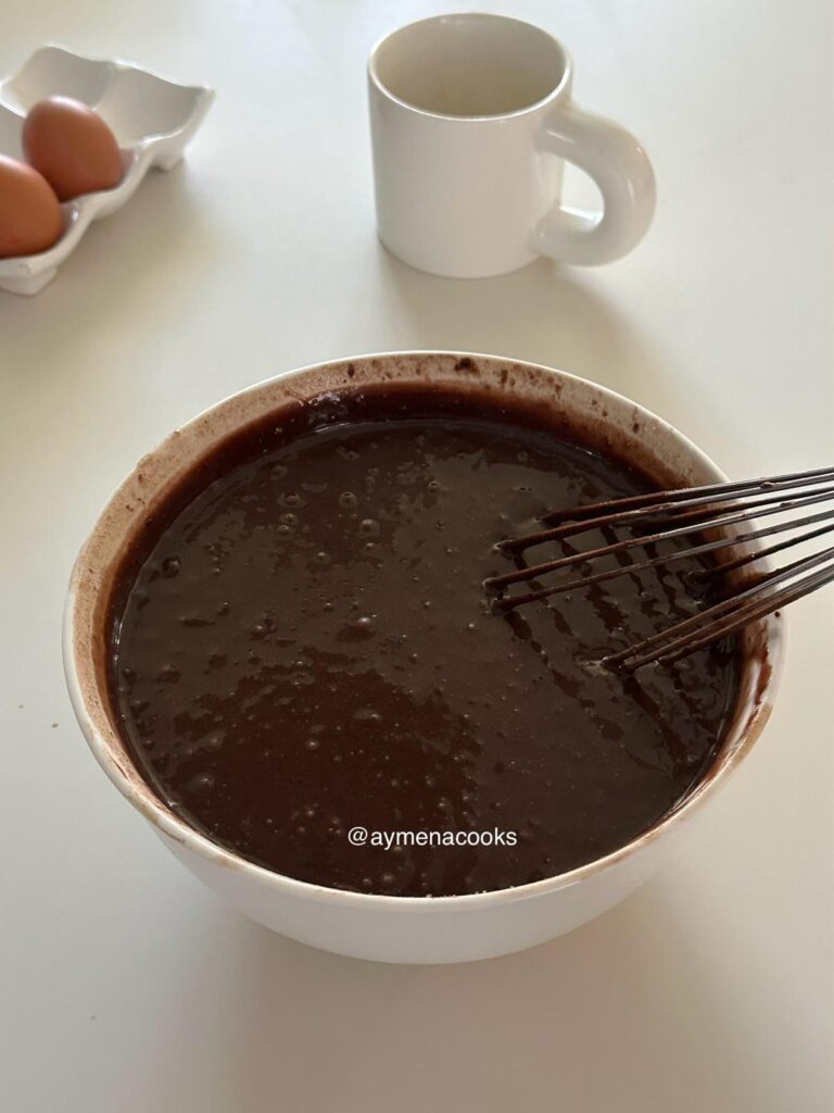 Fluid, thinner chocolate cake batter, after the wet and dry ingredients have been mixed and the hot coffee has been whisked in.