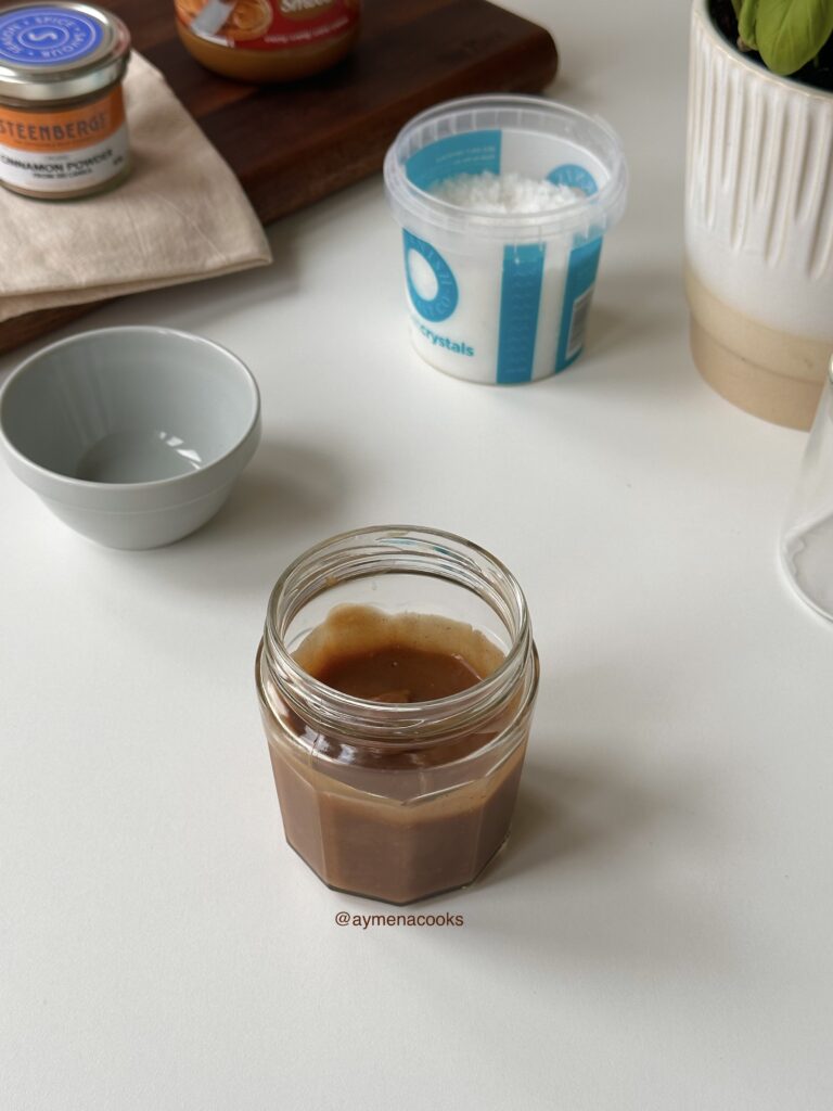 Warm homemade cookie butter syrup in a glass storage jar.