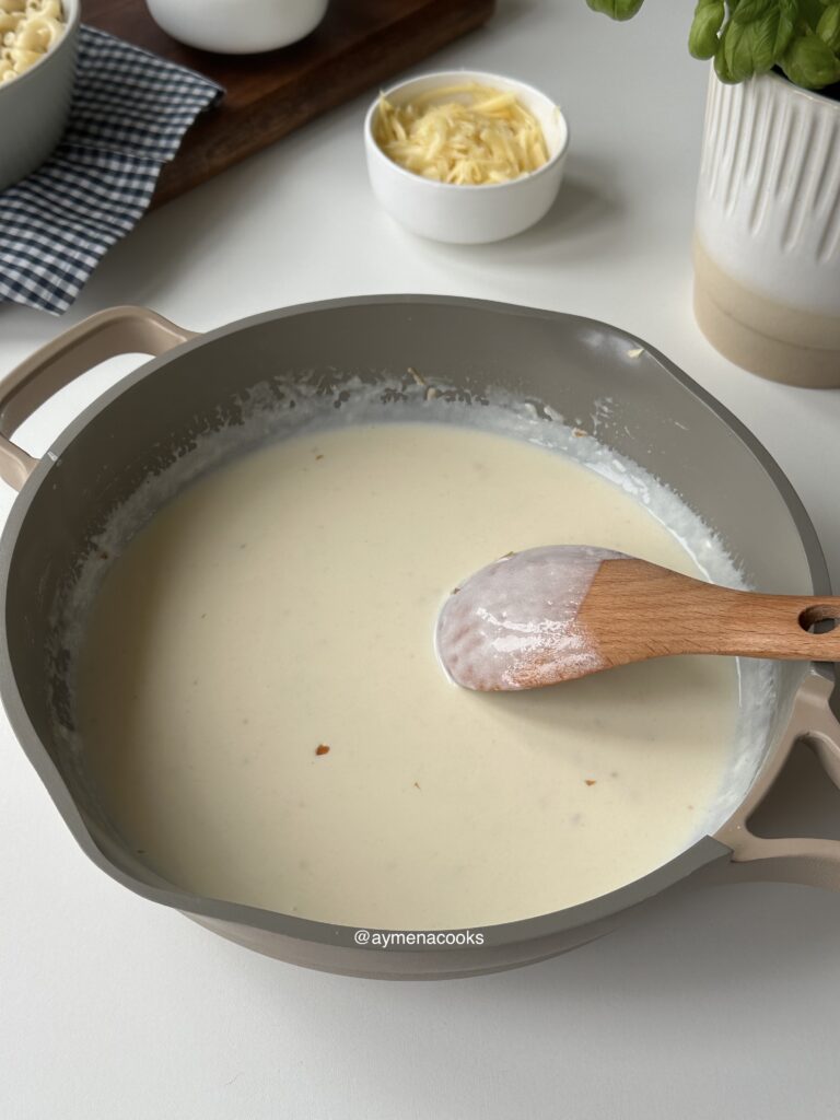 Thickened milk and cream sauce coating the back of a spoon.