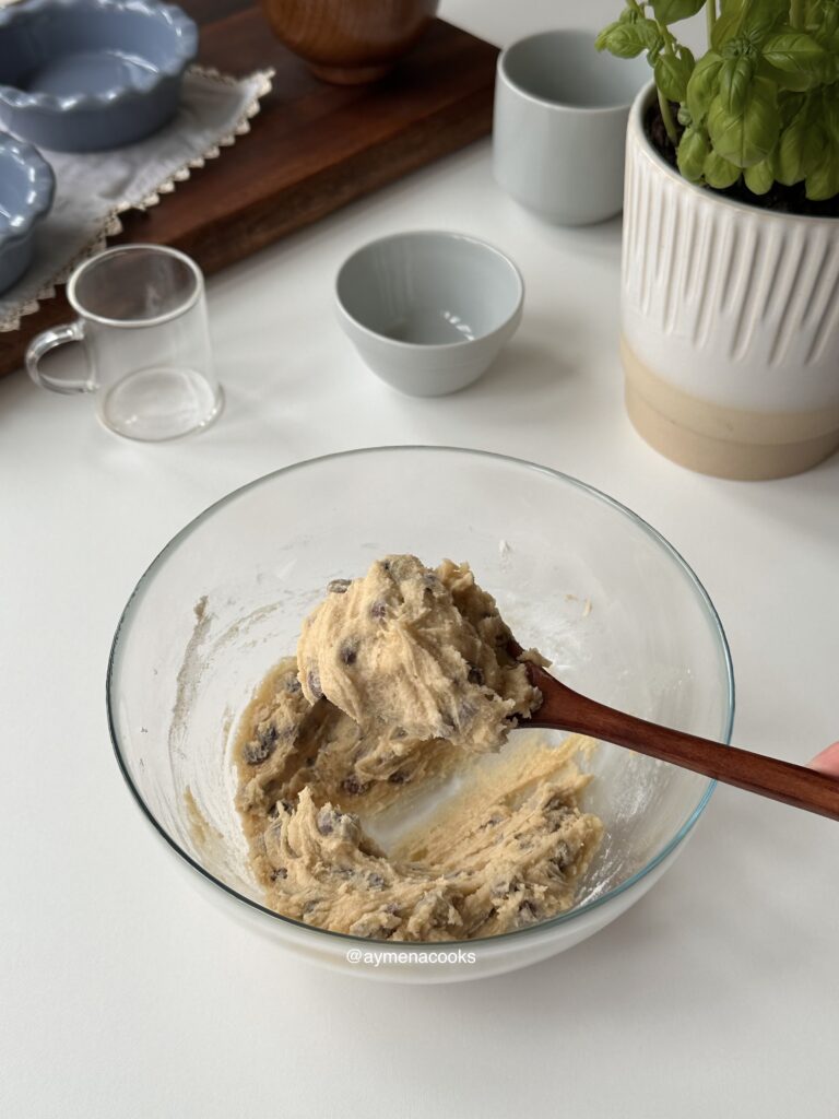 Thick sticky chocolate chip cookie dough ready for mini cookie pies.
