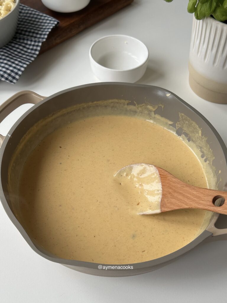 Smooth glossy three-cheese sauce ready for the macaroni.