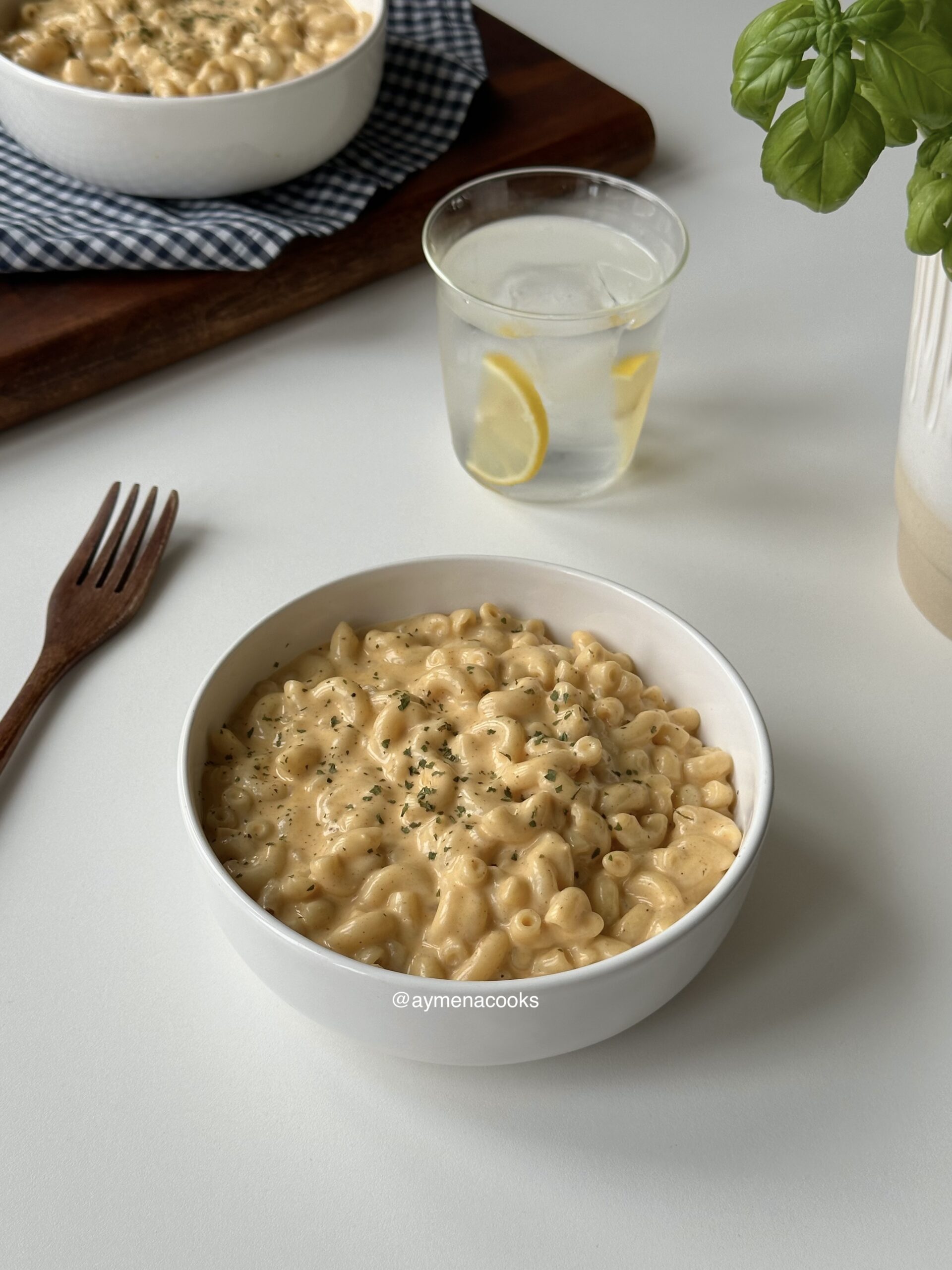 Creamy stovetop mac and cheese with macaroni coated in a glossy three-cheese sauce served in a bowl.