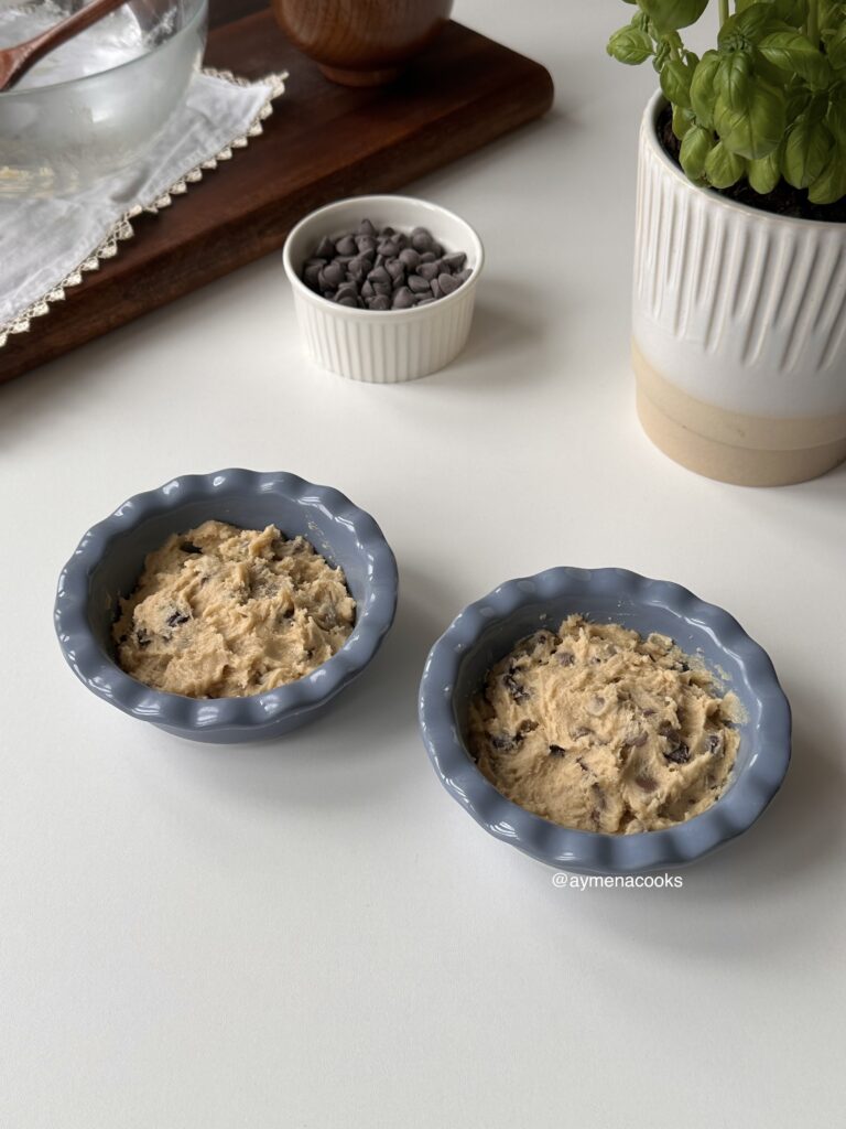 Mini cookie pies ready to bake with the chocolate centres covered by cookie dough.