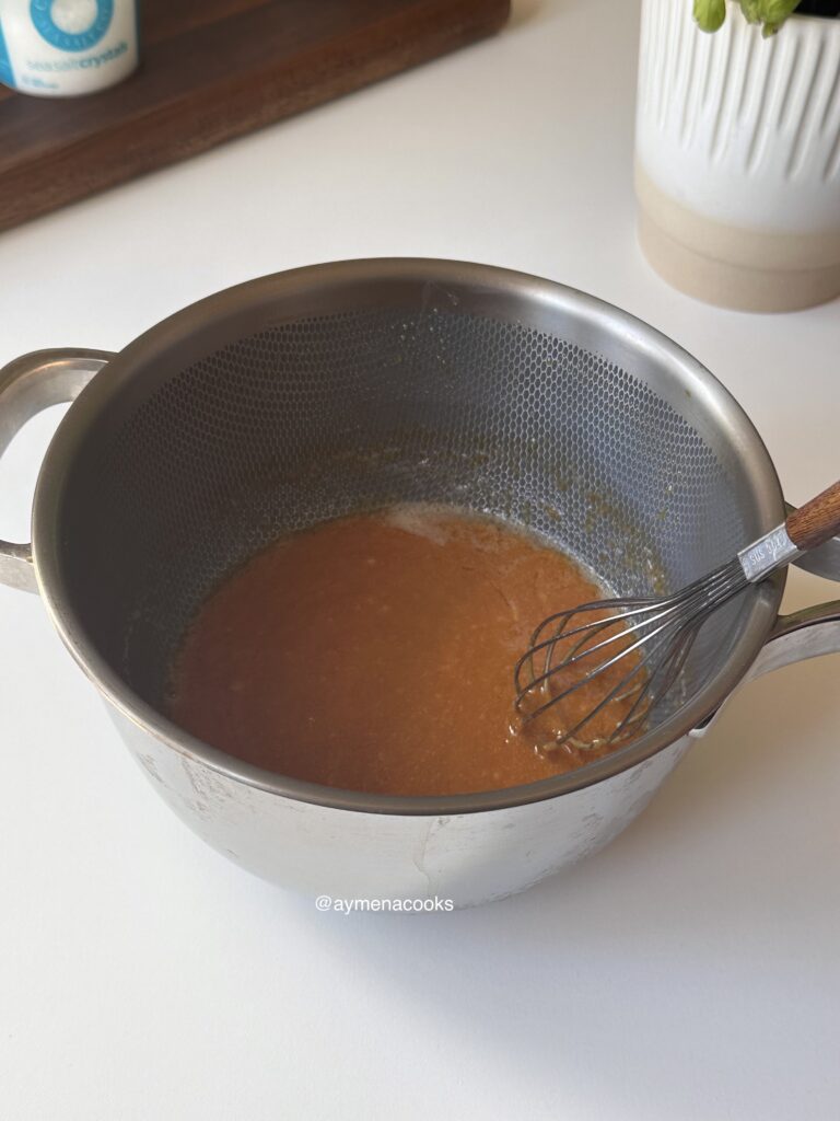 Butter whisked into melted sugar until smooth and glossy.
