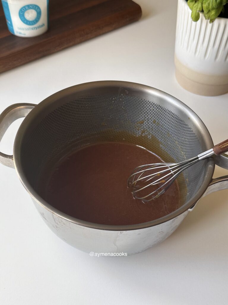 Homemade caramel sauce whisked until smooth and glossy.