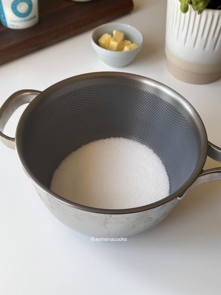 Granulated sugar in a saucepan.