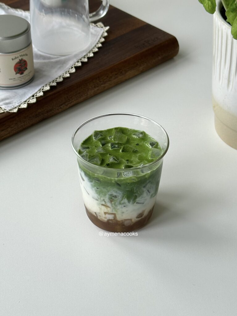 Iced banana matcha latte with cold milk, ice and banana bread syrup.