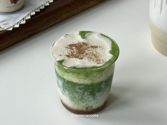 Layered iced banana matcha topped with creamy banana cold foam and a light dusting of cinnamon.