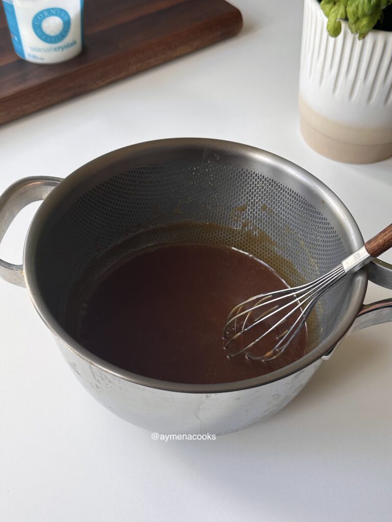 Homemade caramel sauce whisked until smooth and glossy.