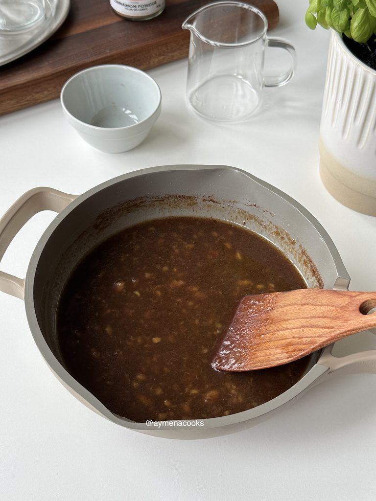 Glossy homemade banana syrup in a pan before being strained.