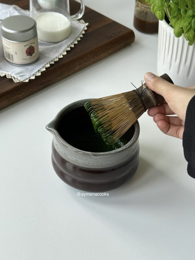 Matcha powder mixed with a small amount of hot water to form a smooth paste.