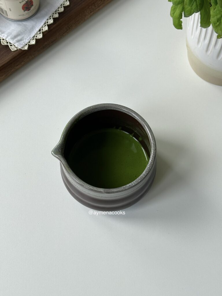 Thick and foamy matcha mixture in a chawan.