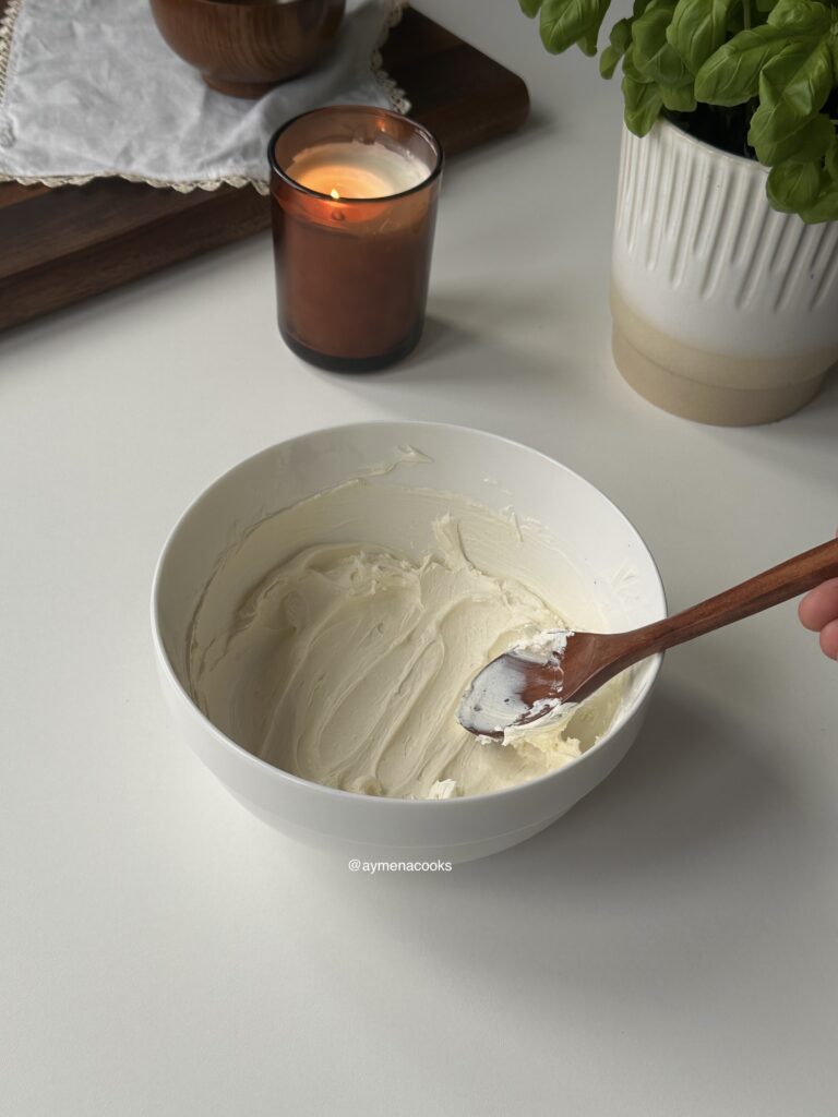 Smooth mascarpone in a small mixing bowl.