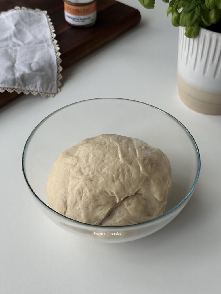 Cinnamon roll dough doubled in size after the first rise.