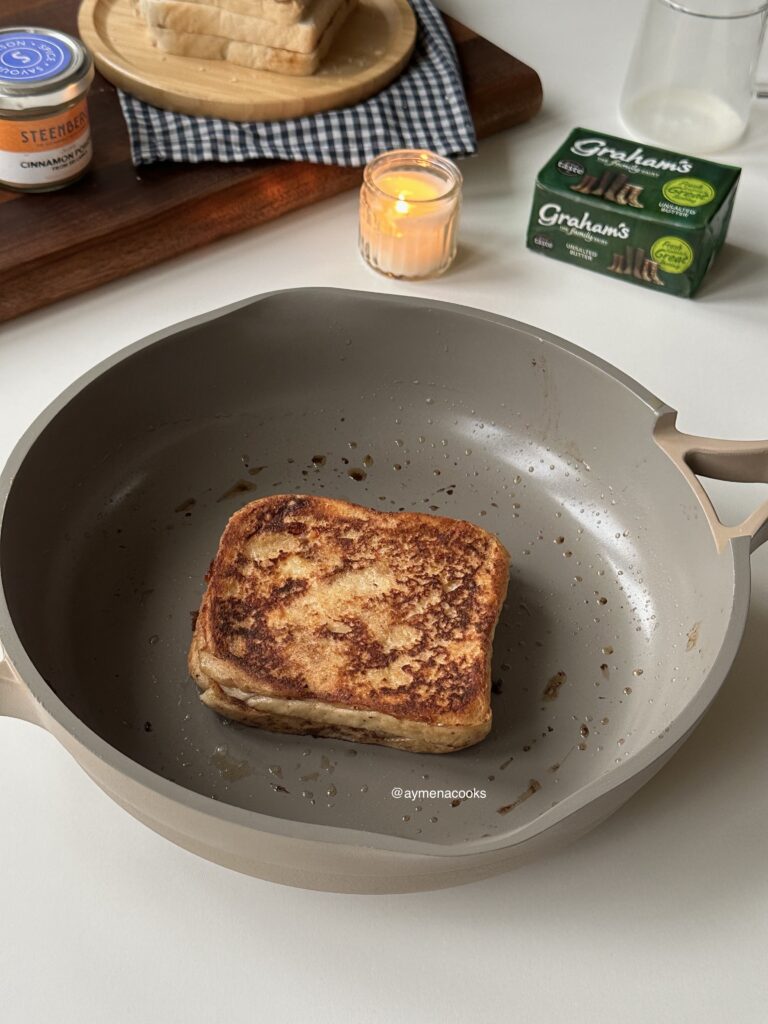 Cinnamon roll French toast sandwich cooked until golden on both sides.