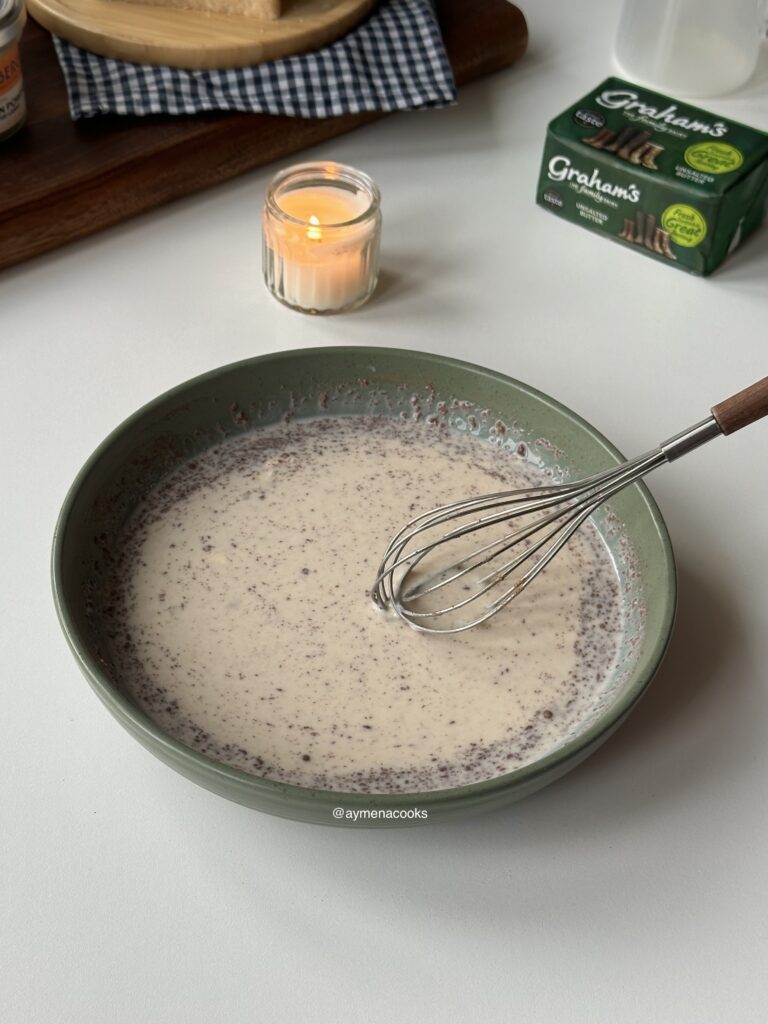 Vanilla and cinnamon custard whisked for cinnamon roll French toast.