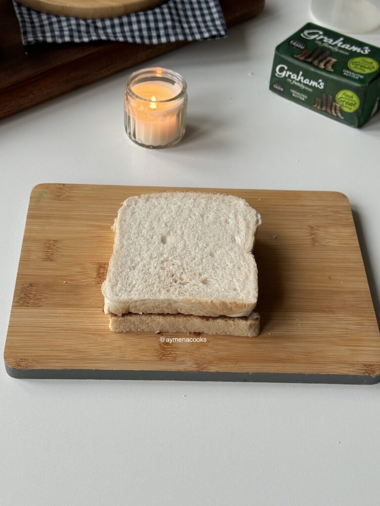 A cinnamon-filled bread sandwich ready to dip in French toast custard.
