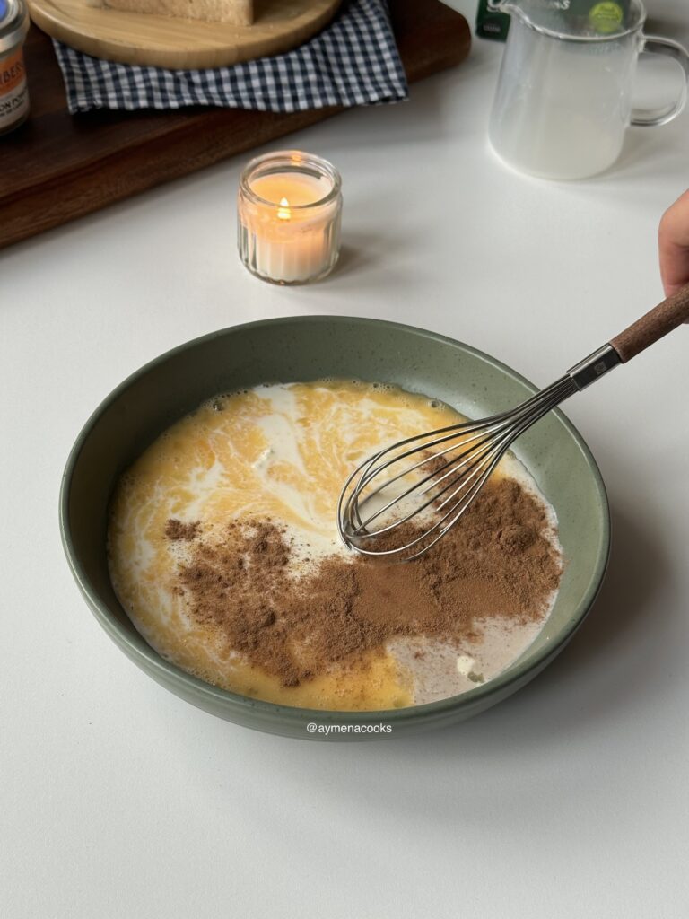 Ingredients for French toast custard being whisked in a wide and shallow bowl.