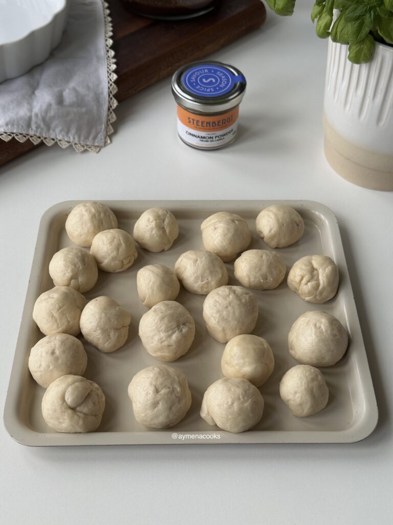 Small pieces of cinnamon roll dough rolled into smooth balls.