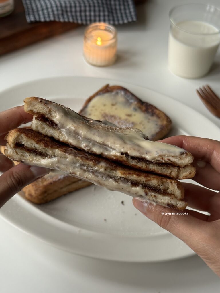Cinnamon roll French toast cut open to show the cinnamon filling.