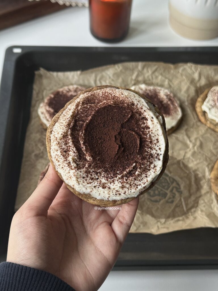 Tiramisu cookie with cocoa powder sifted over the mascarpone frosting.